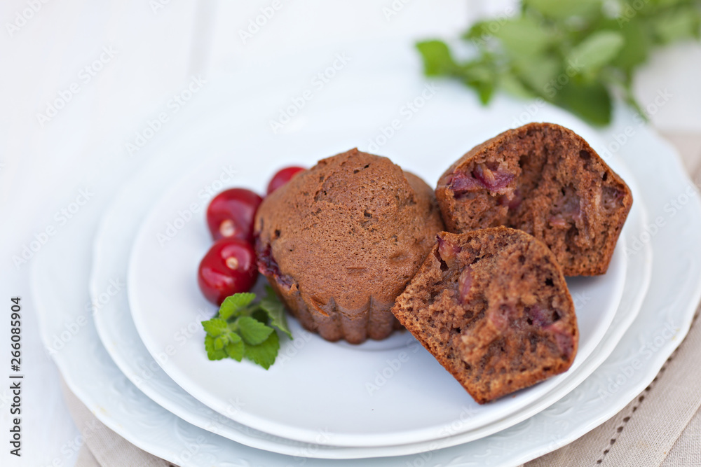 Chocolate muffin with fruits on white plate Chocolate muffin with fruits on white plate