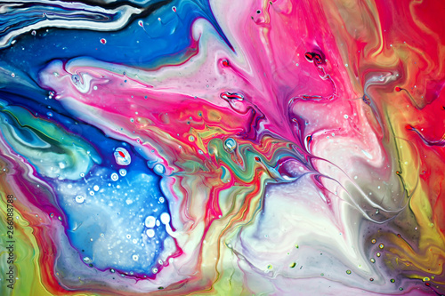 Abstract multi-colored paint background. Acrylic texture with marble pattern. Wallpaper. Mixing paints. Modern art.