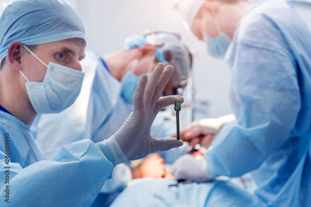Spinal surgery. Group of surgeons in operating room with surgery equipment. Laminectomy Spinal surgery. Group of surgeons in operating room with surgery equipment. Laminectomy