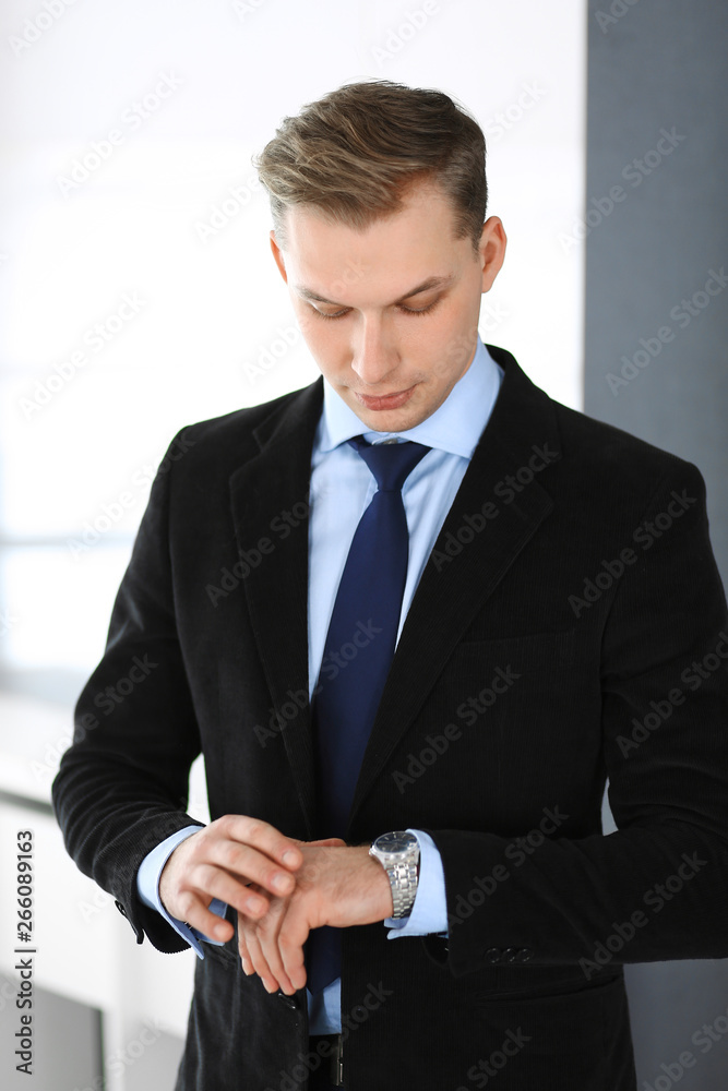 Headshot of businessman standing straight in office. Success and business workplace concept Headshot of businessman standing straight in office. Success and business workplace concept