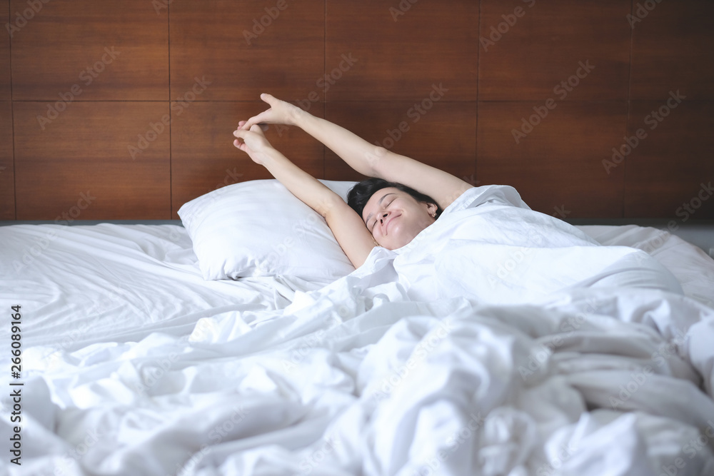 Beautiful young woman waking up in bed. Lazy morning Beautiful young woman waking up in bed. Lazy morning