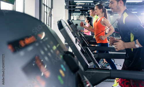 People exercising on treadmill photo