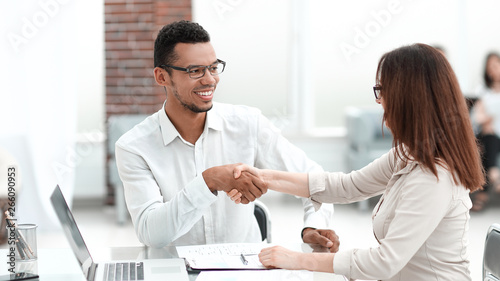 businessman and businesswoman making a deal in a modern office