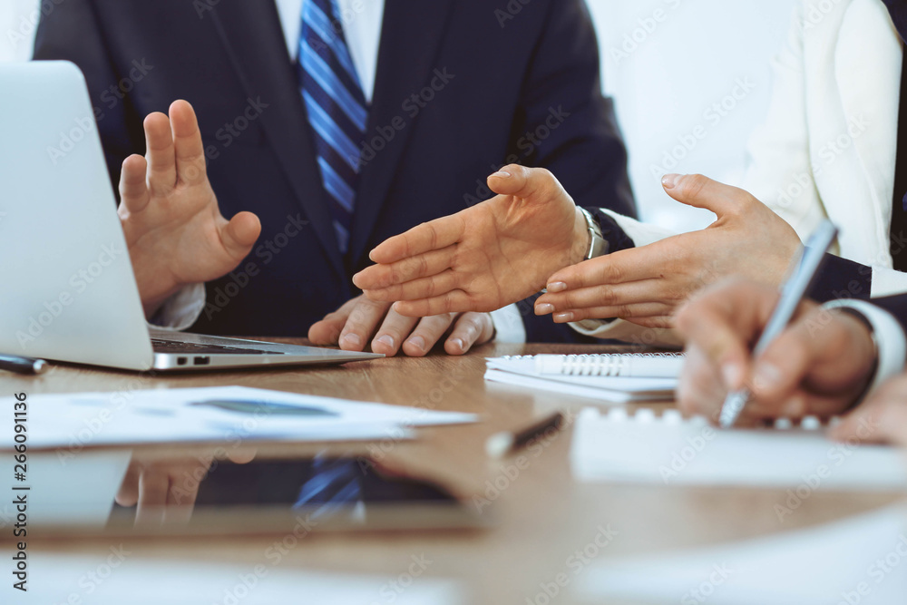 Group of business people or lawyers at meeting, hands close-up Group of business people or lawyers at meeting, hands close-up