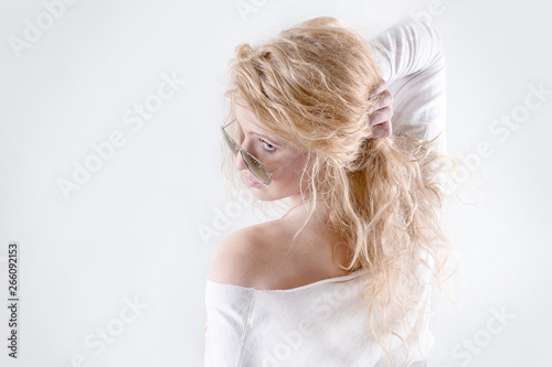 stylish young blonde woman isolated on light background
