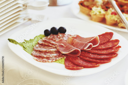 slices of salami and meat on the festival table