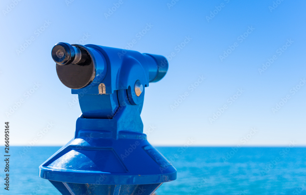 Blue touristic telescope with copy space available.