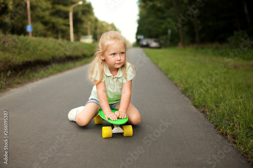 A little girl riding on a skateboard