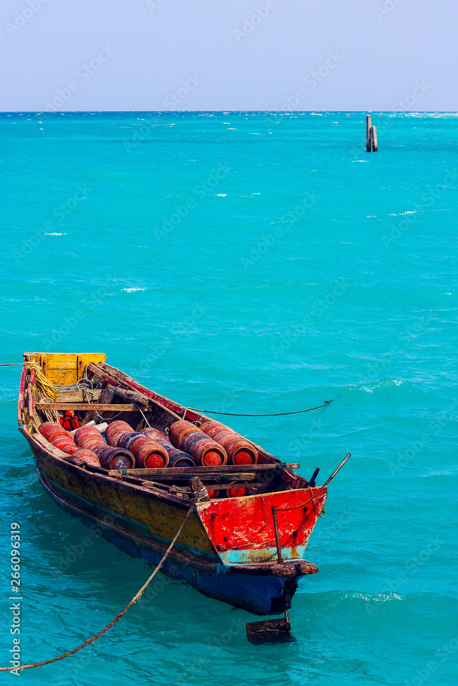 old colorful fisherman boat in a blue sea of  Havelock Island, Andaman and Nicobar Islands