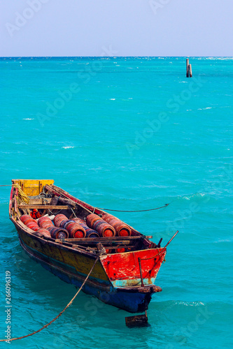 old colorful fisherman boat in a blue sea of  Havelock Island, Andaman and Nicobar Islands