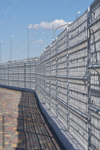 Metal perimeter fence in city.