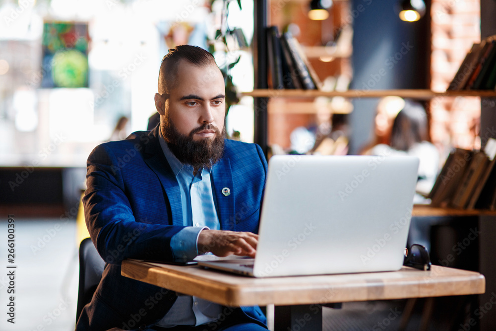 custom made wallpaper toronto digitalBusinessman bearded man in a suit works behind the laptop sitting in a comfortable office coworking.