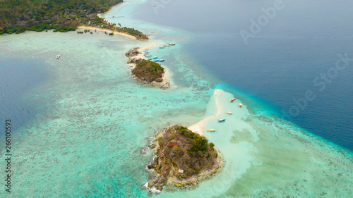 Island with a sand spit and coral reefs. Clear transparent sea near the island Bulog Dos © Tatiana Nurieva
