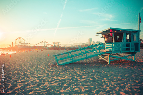 Fototapeta Naklejka Na Ścianę i Meble -  Iconic Santa Monica rescue cabin against famous amusement park in sunset