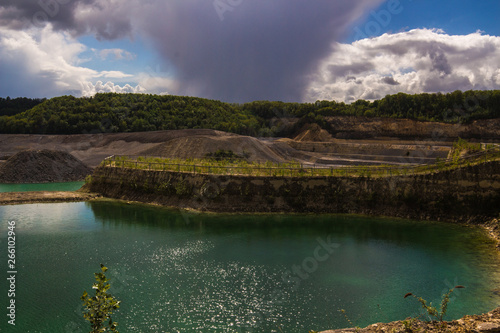 Old marl quarry in Maastricht which is converted into a public park with natural pools, with a dramatic sky