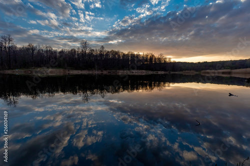 Clouds reflected on the water surface of the Pioneer pond shot in the spring at sunset