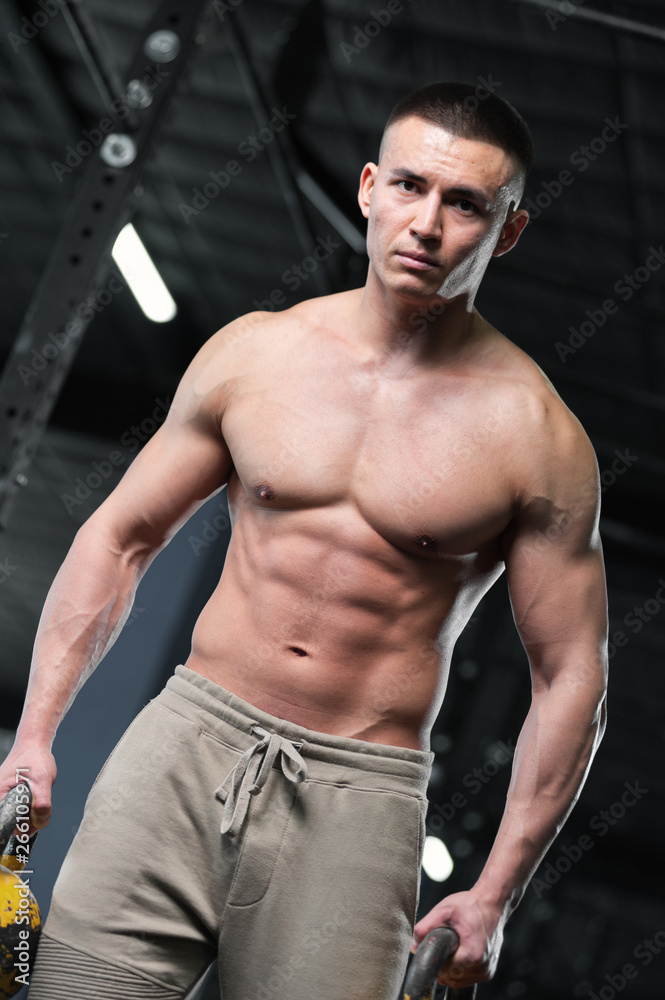 Athletic Shirtless Man Showing Well Trained Body and Abdominal Muscles. Athletic Shirtless Man Showing Well Trained Body and Abdominal Muscles.