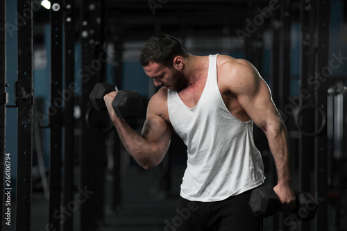 Strong Athletic Young Man With Dumbbells