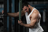 Muscular Handsome Man Posing in Gym.