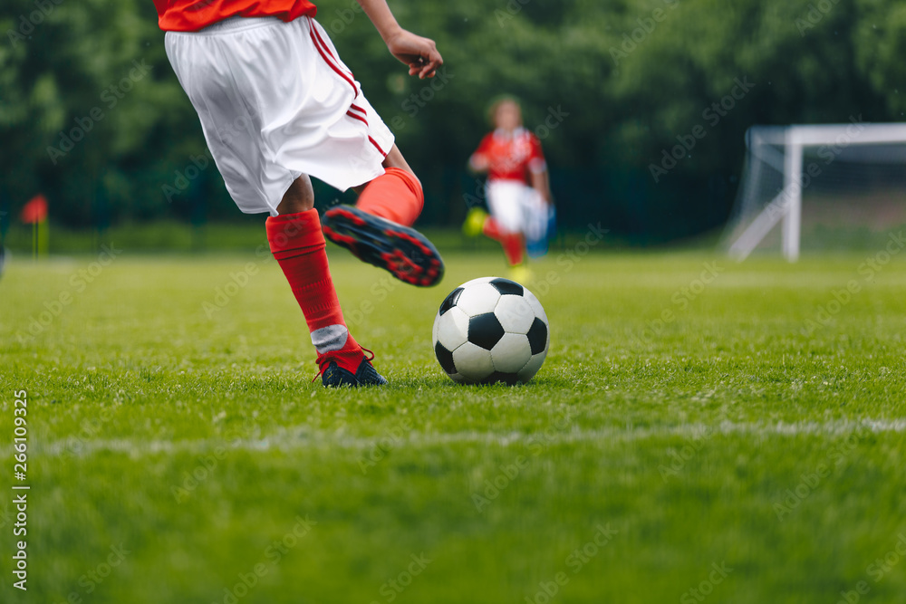 Football Kick on the Field. Player Kicking Soccer Ball Football Kick on the Field. Player Kicking Soccer Ball
