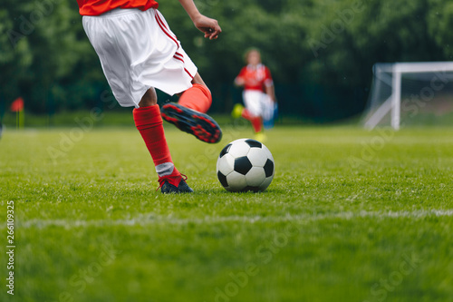 Fototapeta Naklejka Na Ścianę i Meble -  Football Kick on the Field. Player Kicking Soccer Ball