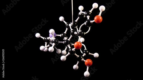 Morphine C17H19NO3 molecule isolated on black background rotating photo