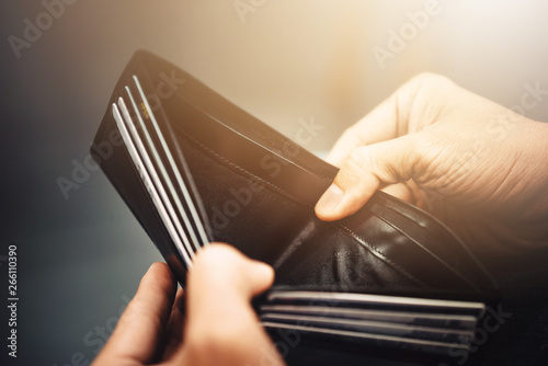 Empty wallet (no money) in the hands of an Businessman