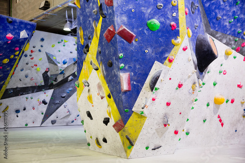 Colored climbing wall for training at modern bouldering gym