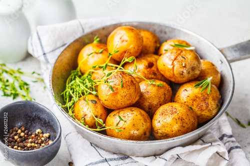 Baked potatoes in a cast iron skillet.