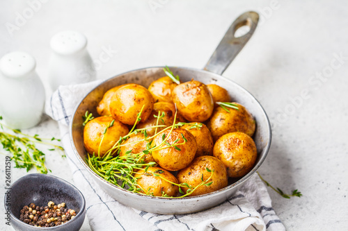 Baked potatoes in a cast iron skillet. photo