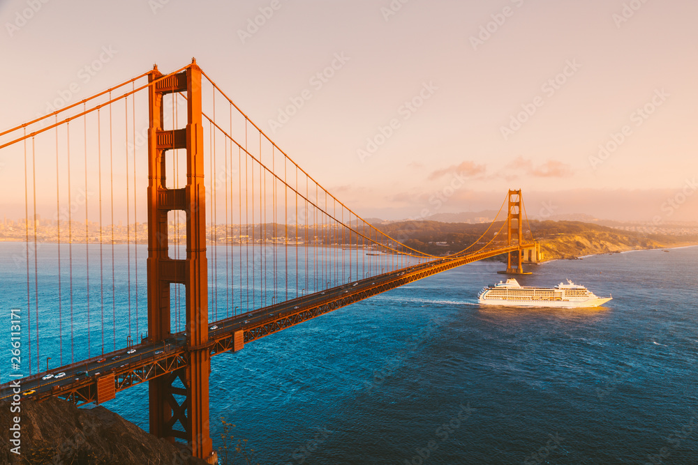 Golden Gate Bridge with cruise ship at sunset, San Francisco, California, USA