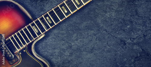 Old jazz electro guitar on a dark background. Close up. Copy space. Background for music festivals, concerts. Music background.