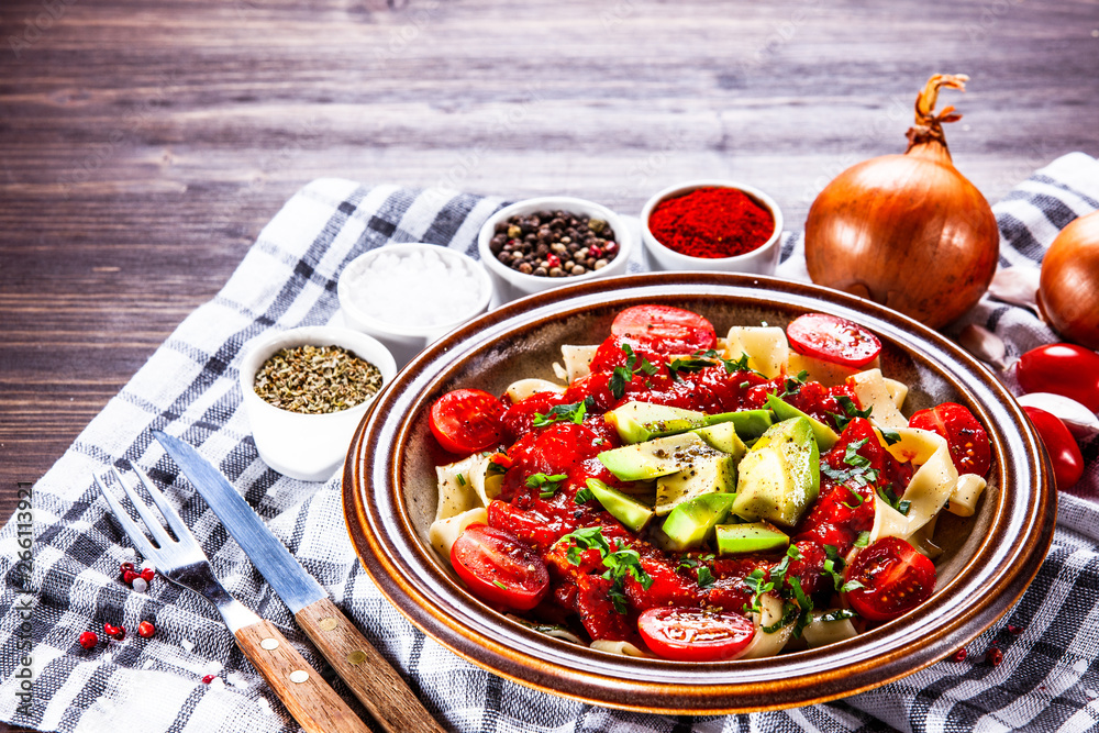 Pasta with herbs and vegetables on wooden background Pasta with herbs and vegetables on wooden background