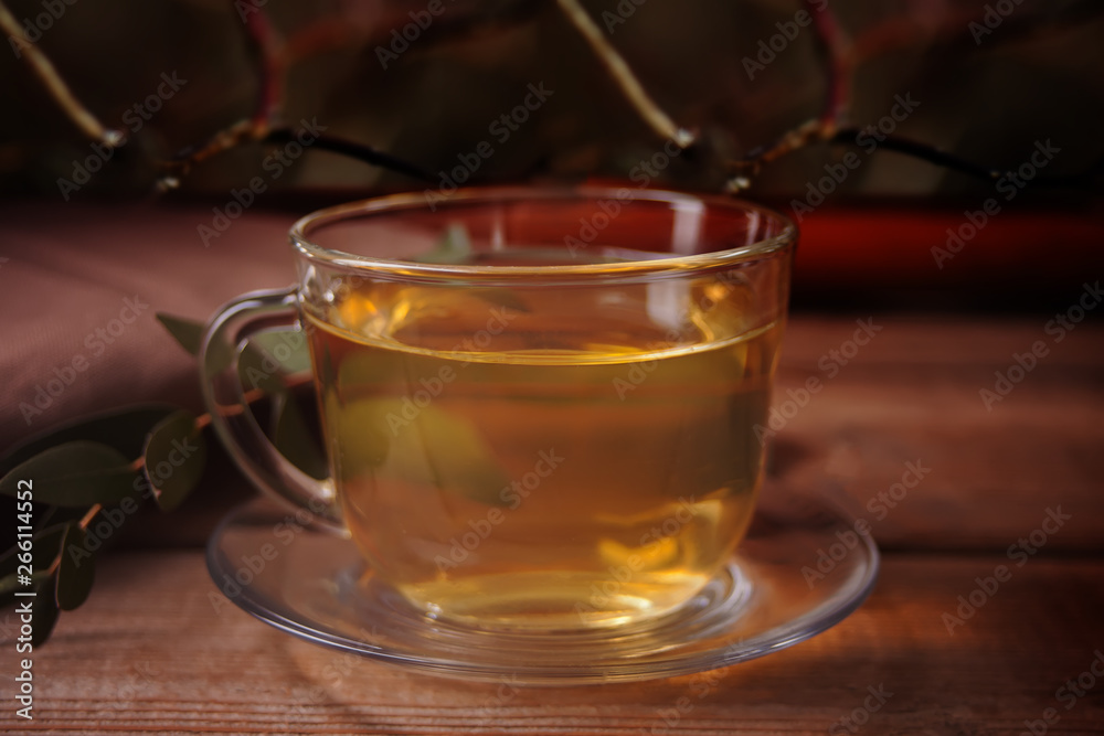 Cup of tea on dark background on the wooden background