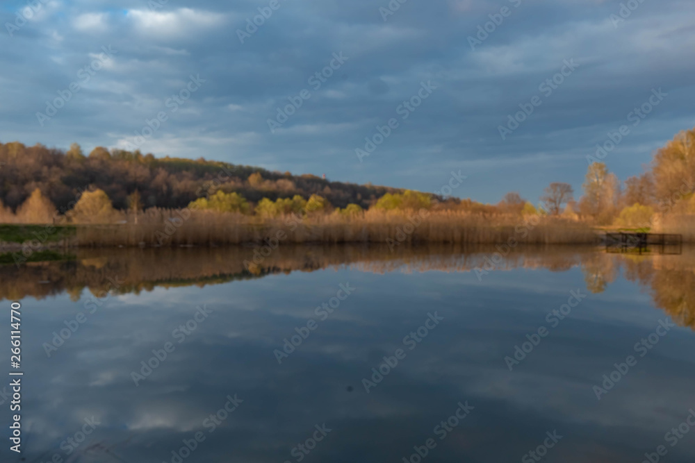 forest pond with reflections of clouds shot in the spring at sunset forest pond with reflections of clouds shot in the spring at sunset