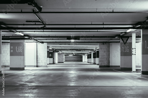 Parking garage in the underground. Asphalt and empty parking lots.