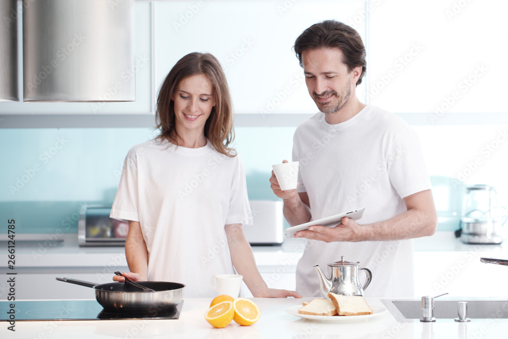 Couple cooking breakfast