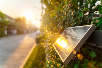 Small solar panel on wall with sunlight. Green energy in home concept.
