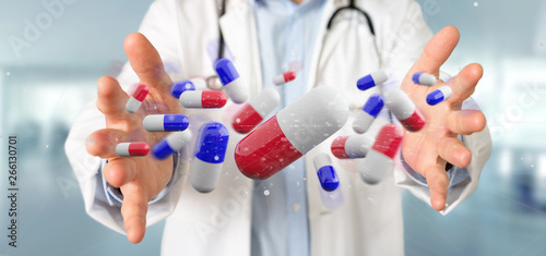 Doctor holding a 3d rendering group of medical pills