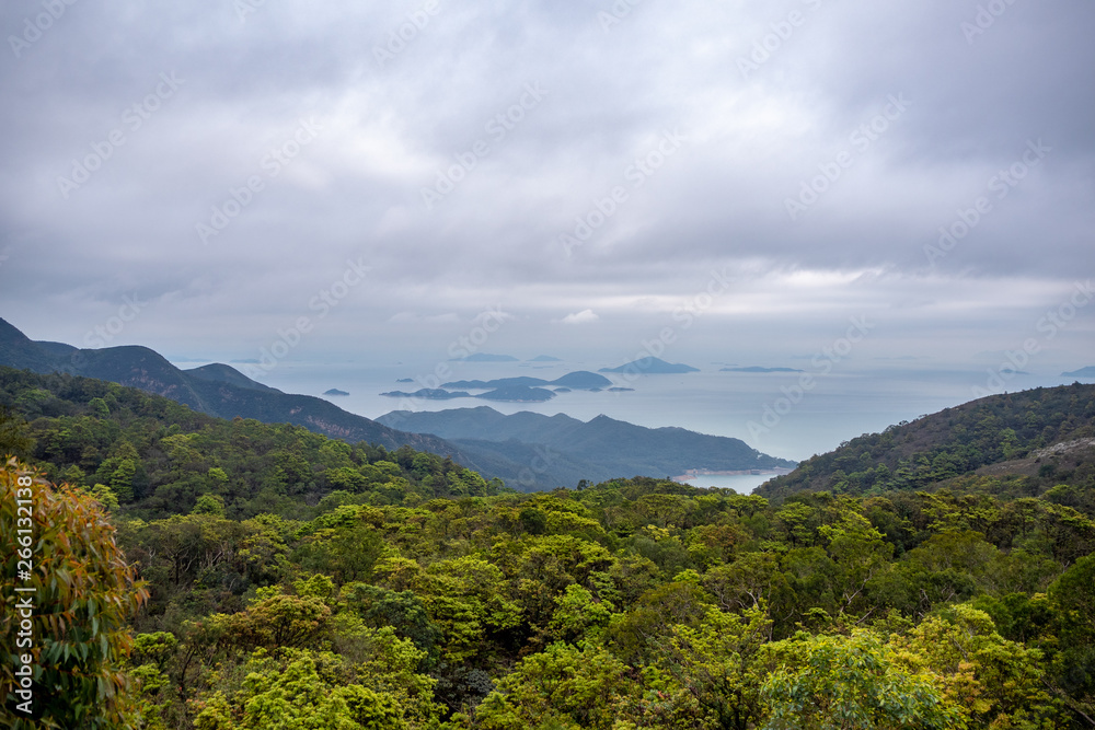 Beautiful panorama view of a mountain full of fresh green trees and sea with clouds sky for background Beautiful panorama view of a mountain full of fresh green trees and sea with clouds sky for background