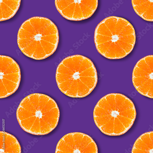 Seamless pattern made of tangerine on a purple background