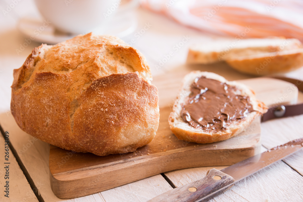 Sliced loaf of wheat bread with peanut butter for breakfast