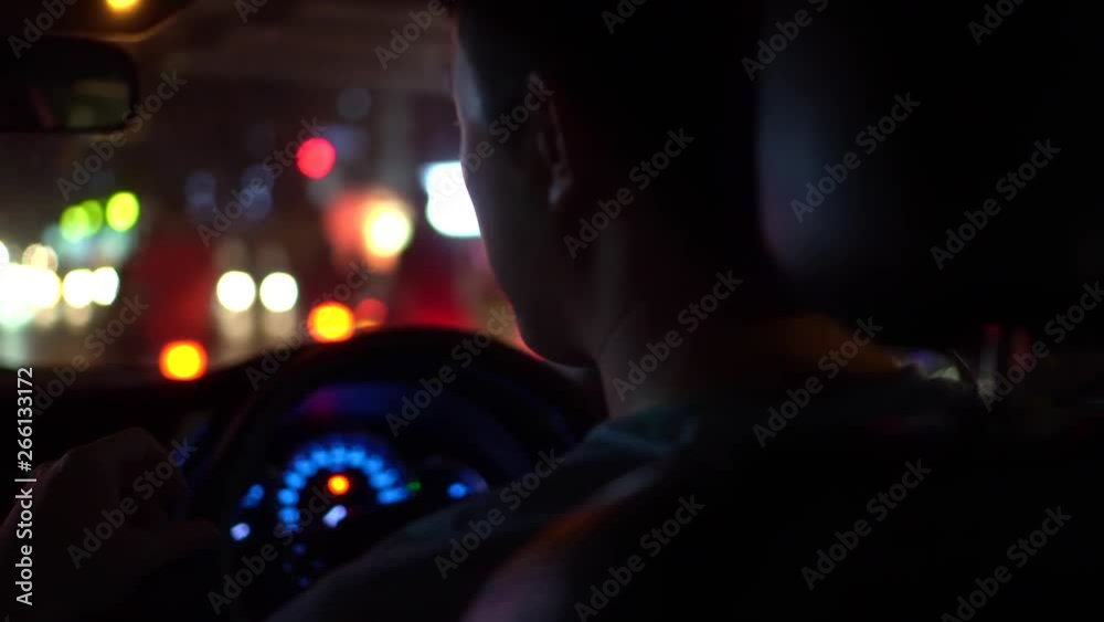 Man in car traffic at night Man in car traffic at night