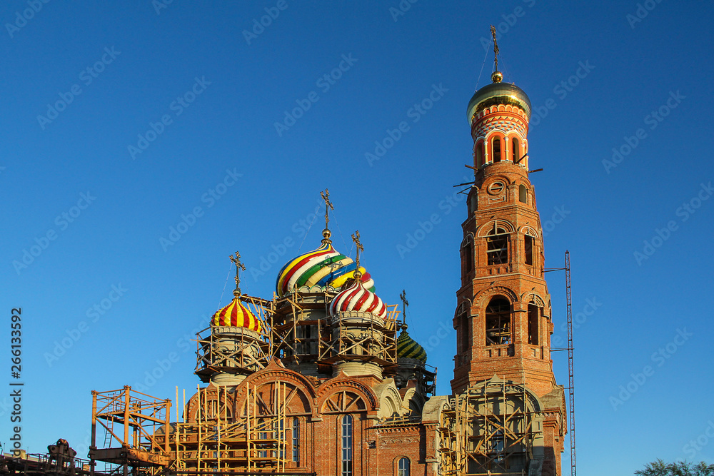 Orthodox Church under construction with multi-colored ceramic domes