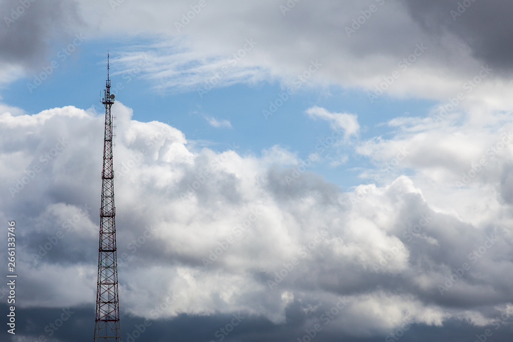 Cell tower on a cloudy sky background Cell tower on a cloudy sky background