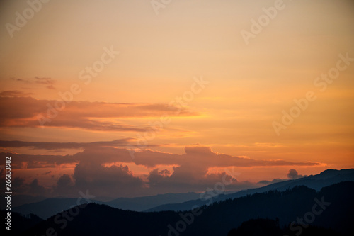 sunset in the austrian alps with silhouette of colorful clouds and mountains in the austrian alps in styria