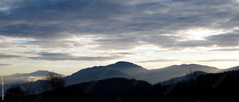 sunrise in the austrian alps shining at mystic clouds up sleeping hilltops in styria