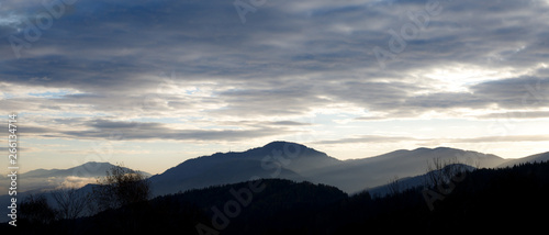 sunrise in the austrian alps shining at mystic clouds up sleeping hilltops in styria