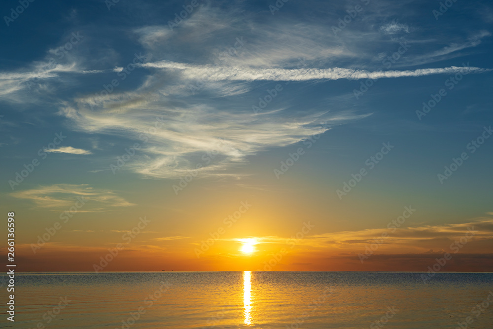 Colorful sunset over calm sea water near tropical beach. Summer vacation concept. Island Phangan, Thailand