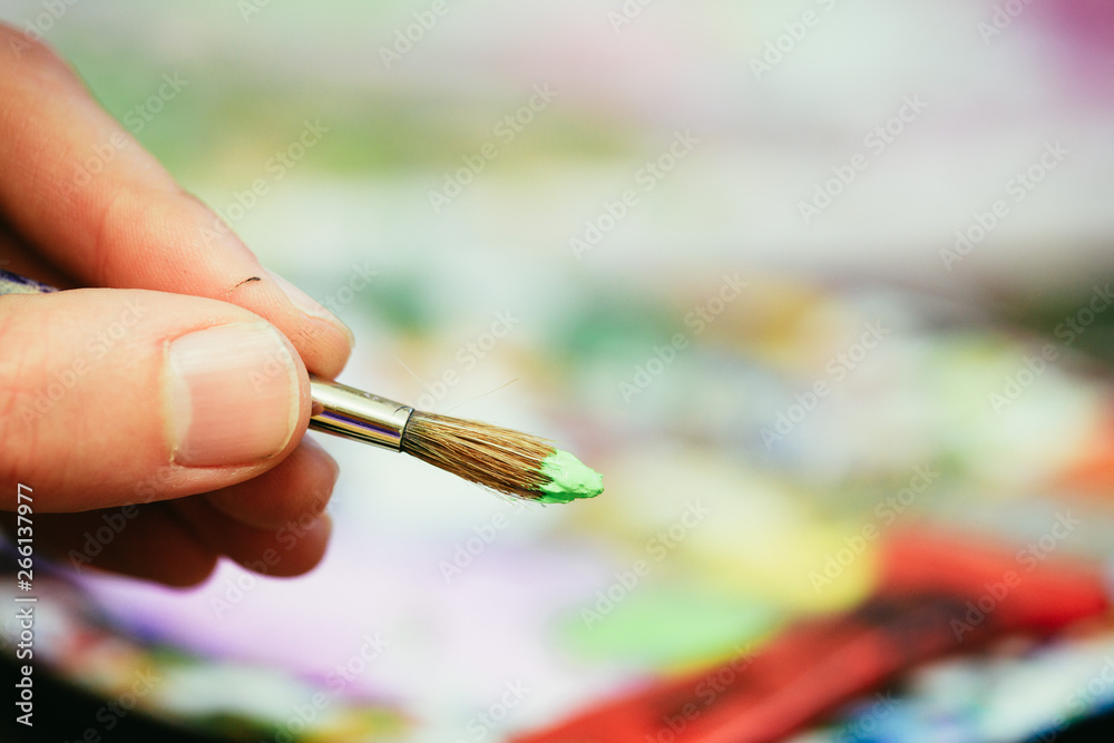 Painting artwork: paint brushes on painting background Painting artwork: paint brushes on painting background